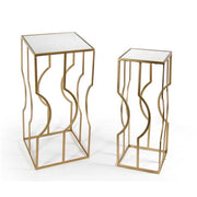 Conjunto de dos mesas de salón en metal dorado